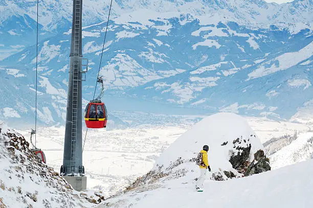 ski lift at beautyful Austrian alps  mountains and snowboarder woman looking at view