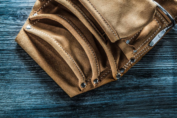 istock Leather tool belt on wooden board 1065818942