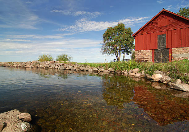 house and tree on coast of lake Vattern, Sweden