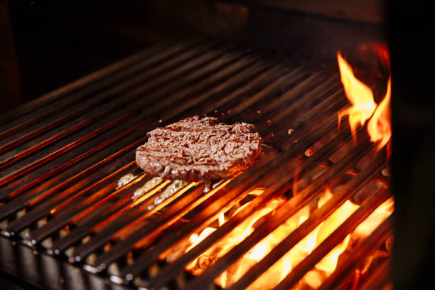 istock Chef making burger. Cooking hamburger. Beef or pork cutlet grilling on grid 1065819230