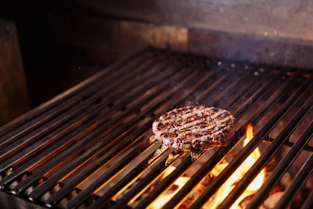 istock Chef making burger. Cooking hamburger. Beef or pork cutlet grilling on grid 1065819376
