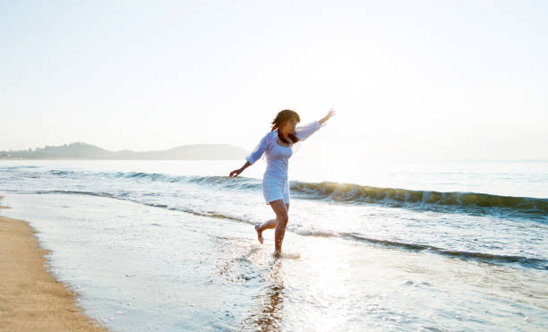 istock Happy woman playing on the beach 1065819892