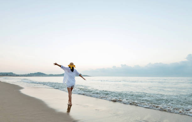 istock Happy woman playing on the beach 1065820042