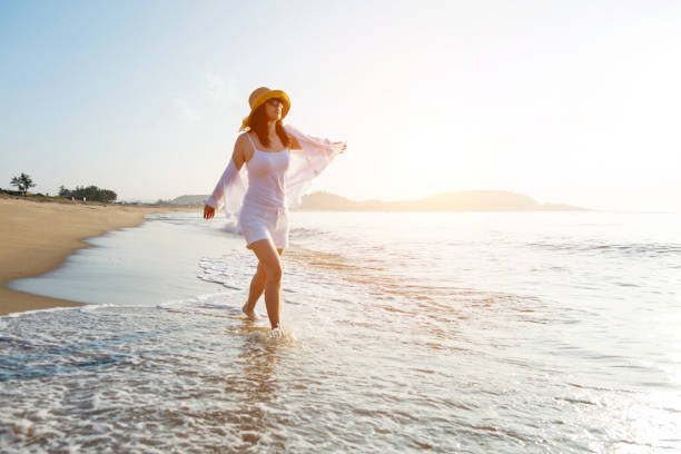 istock Happy woman walking on the beach 1065820460
