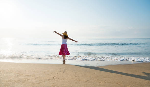 istock Happy woman playing on the beach 1065820504