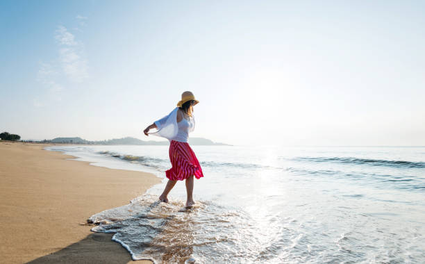 istock Happy woman playing on the beach 1065821994