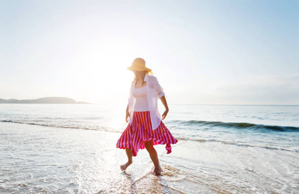 istock Happy woman playing on the beach 1065822108