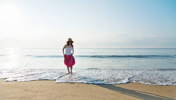 istock Happy woman playing on the beach 1065822398