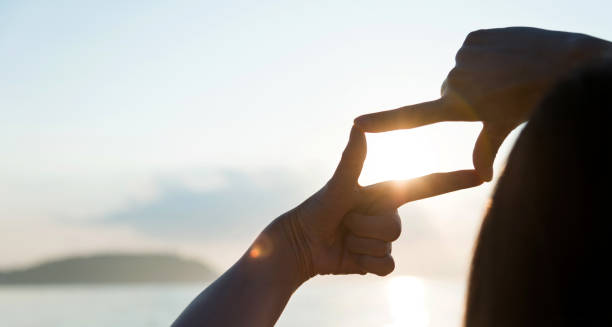 istock Woman hand making frame around the sun 1065823266
