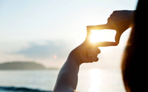 istock Woman hand making frame around the sun 1065824286
