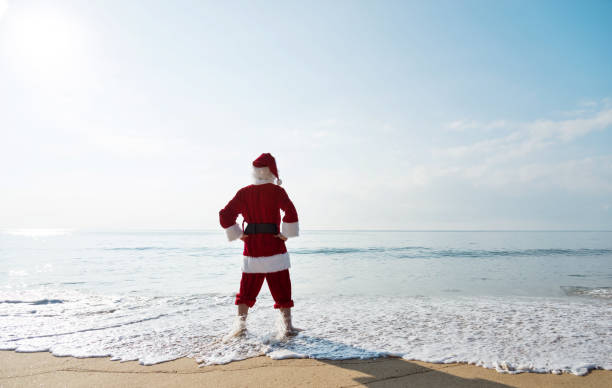 istock Santa Claus standing on sea beach 1065825550