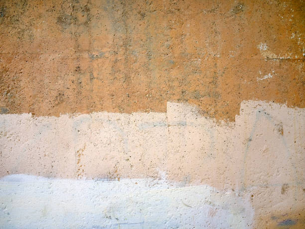 Close-up yellow beige white grunge old cracked wall texture