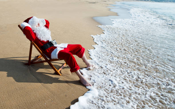 istock Santa Claus resting on deck chair at beach 1065827282