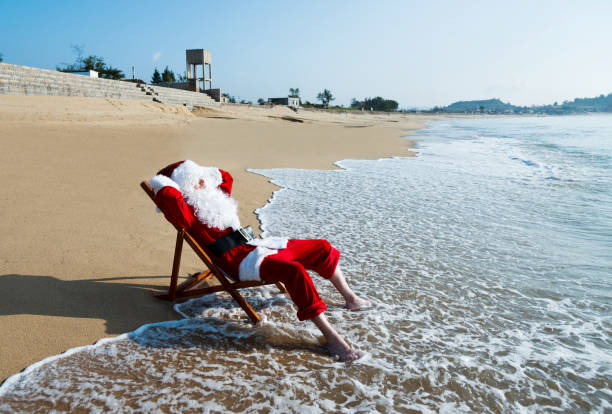 istock Santa Claus resting on deck chair at beach 1065827622