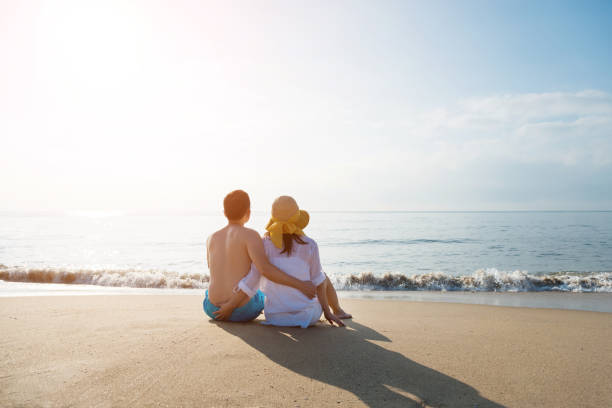istock Couple sitting on the beach 1065828046