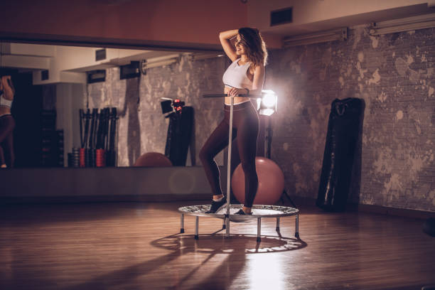 istock Young woman exercising on a mini-trampoline 1065830108