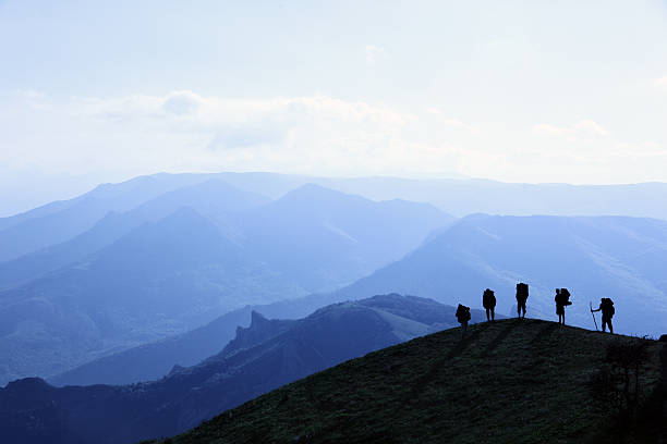 silhouettes of tourists stock photo