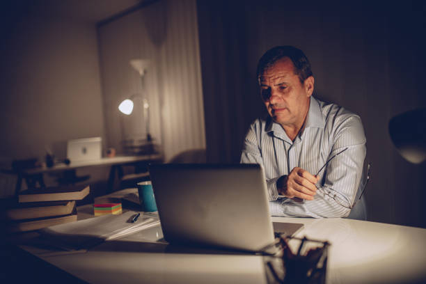 istock Mature man working late at the office 1065832206
