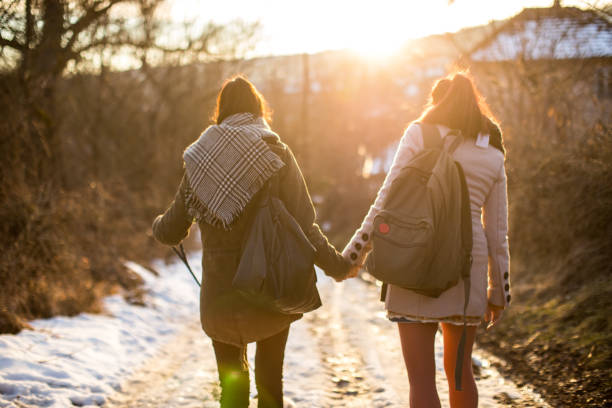 Rear Attractive On Attractive Women, Gay Couple, Walking With  Adorable Puppy On Snowy Day
