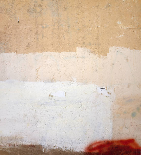 istock Close-up yellow beige white grunge old cracked wall texture 1065840000