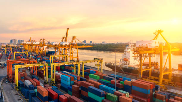 istock Container ship in export and import business and logistics. Shipping cargo to harbor by crane. Water transport International. Aerial view and top view. 1065840374