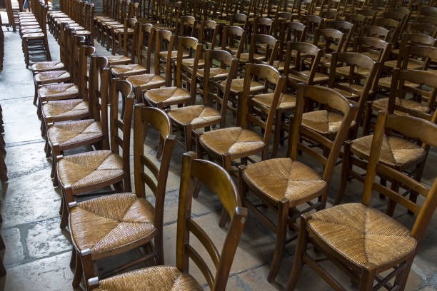 istock Chairs for parishioners in a catholic church. 1065848730