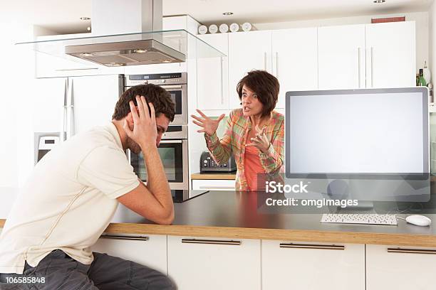 Couple Discussing Personal Finances In Modern Kitchen Stock Photo - Download Image Now