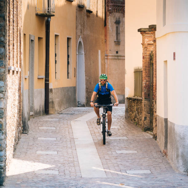 Man bikes through quaint village