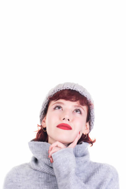 istock young lovely thoughtful woman looking up 1065859424