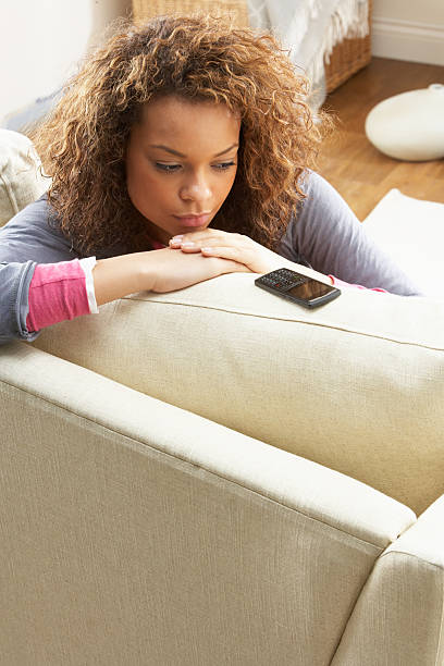 istock Woman Sitting On Sofa Wating For Mobile Phone At Home 106585997