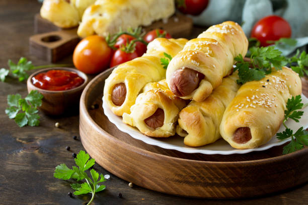 istock Sausage in Dough in rustic style on wooden table. 1065861638