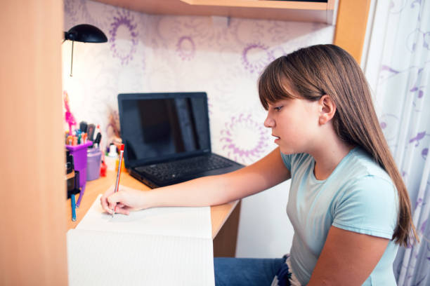 istock Girl doing homework in her bedroom 1065863408