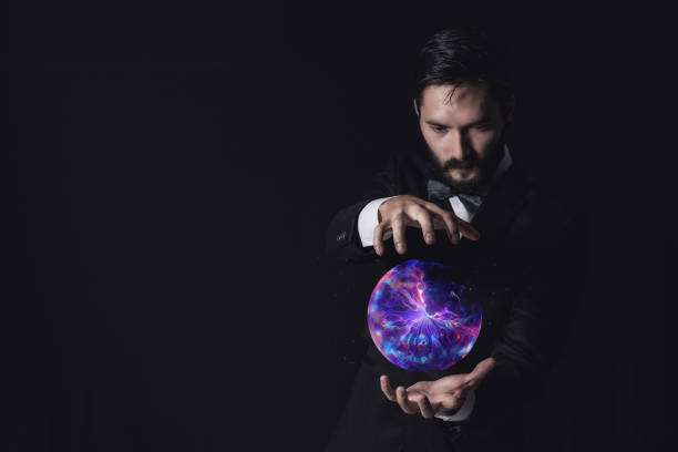 Magician hand showing magic trick on dark background