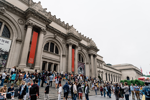 New York City, USA - June 23, 2018: Crowd of people at the main entrance of Metropolitan Museum of Art of New York a cloudy day