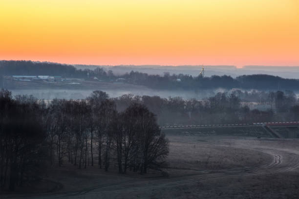 istock Beautiful spring landscape with fog lit with a rising sun 1065868232