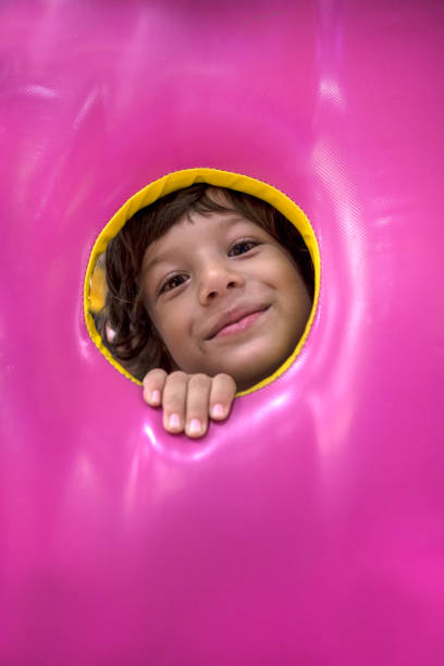 istock Little Happy Boy Looking Through Playhouse Window. 1065870582