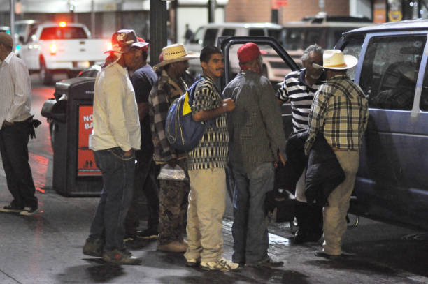 El Paso, TX, US--June 30, 2013. In the early morning hours, workers line up to be hired by a contratista, a contractor who find labor for local farmers.