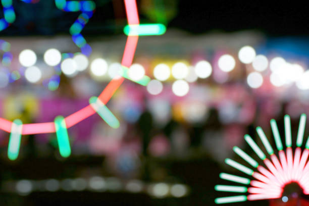 istock Defocused and blurred image of people at amusement park 1065874598
