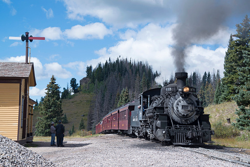 Cumbres Toltec historic narrow-gauge steam train engine stopped at Cumbre Pass on the way to Antonito, Colorado train station USA on September 9, 2018