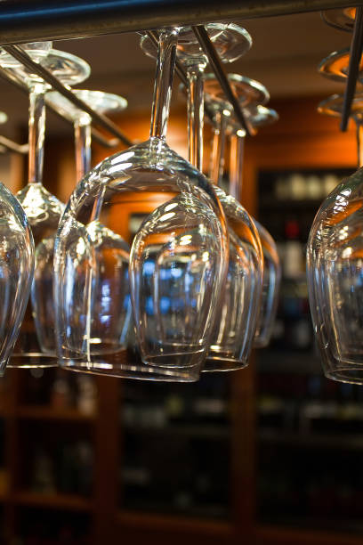 istock shiny glasses for wine with light reflection hanging above bar counter 1065879306