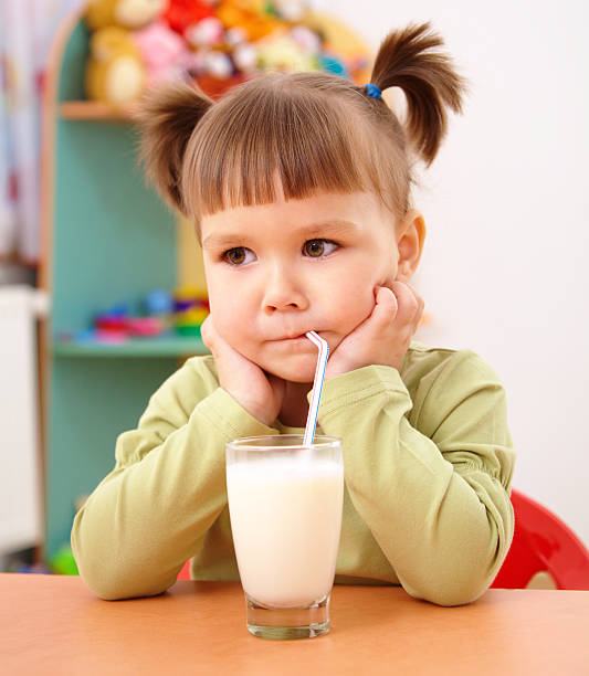 istock Gloomy little girl drinks milk 106588214