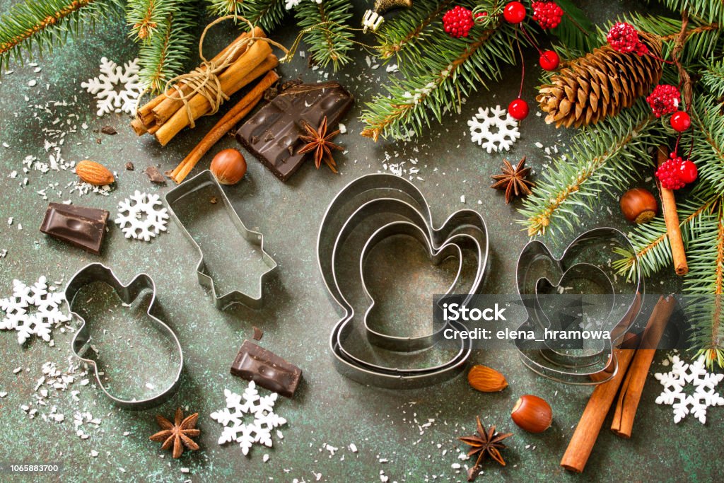 Ingredients for Christmas Gingerbread baking - chocolate, cinnamon, anise and nuts on dark a stone or slate background. Seasonal, food background. Abstract Stock Photo