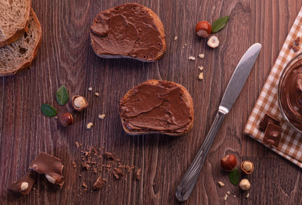istock Black food background with cocoa, nuts and chocolate paste. top view 1065884048