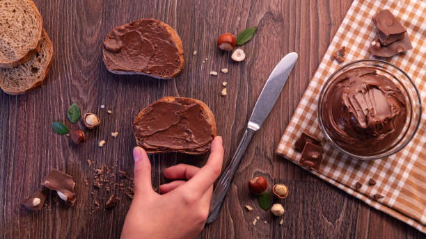 istock Slice of bread with chocolate cream and nuts. Chocolate spread 1065884106