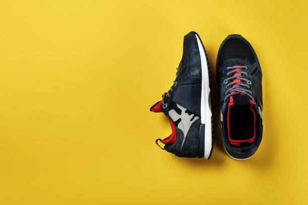 istock New men's sneakers with khaki design on a yellow background. 1065887672