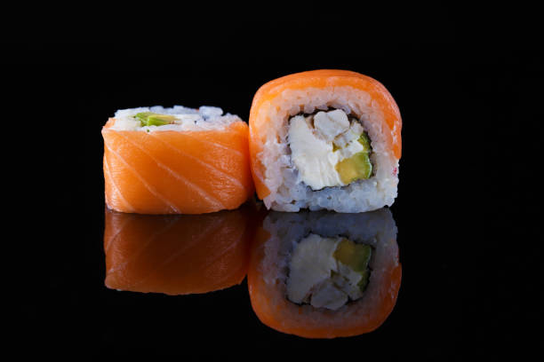 istock delicious California sushi roll on a black background with reflection 1065892568
