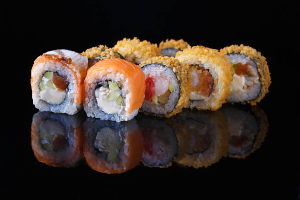 istock delicious set of sushi roll with fish on a black background with reflection Menu and restaurant concept 1065892690