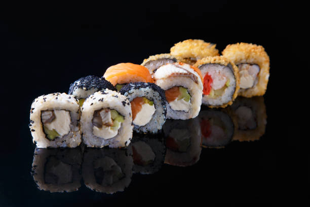 istock delicious set of sushi roll with fish on a black background with reflection Menu and restaurant concept 1065892760