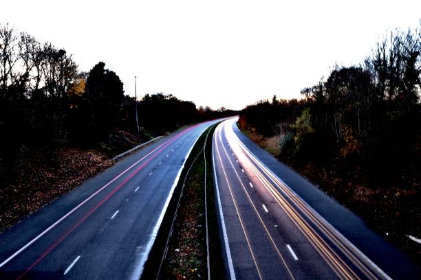 istock Motorway north and south bound car trail light 1065894320