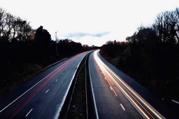 istock Motorway north and south bound car trail light 1065894330